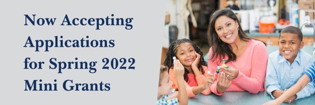 Text reads "Now accepting applications for Spring 2022 Mini Grants" next to an image showing a smiling teacher and engaged students.