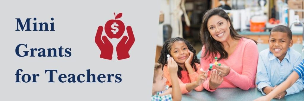 A banner image reads Mini Grants for Teachers. An icon of hands holds an apple with a dollar sign on it. An image shows a teacher and students.