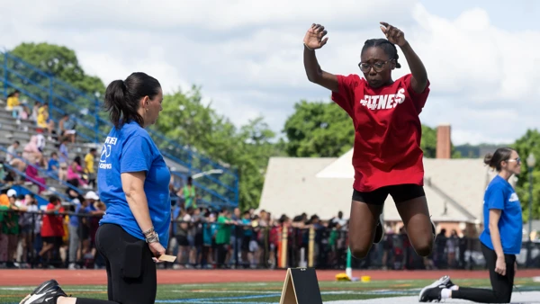 Young women running in a school track race.